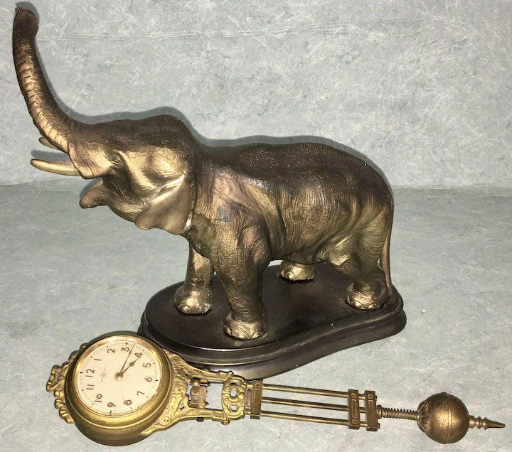 Elephant swinging clock