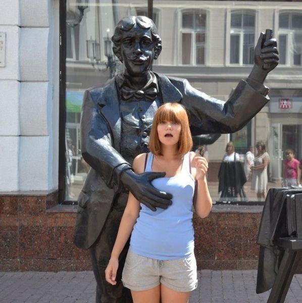 Funny poses with statues